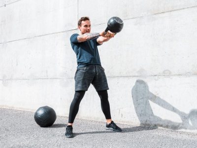 man-exercising-with-a-kettlebell-outdoors-royalty